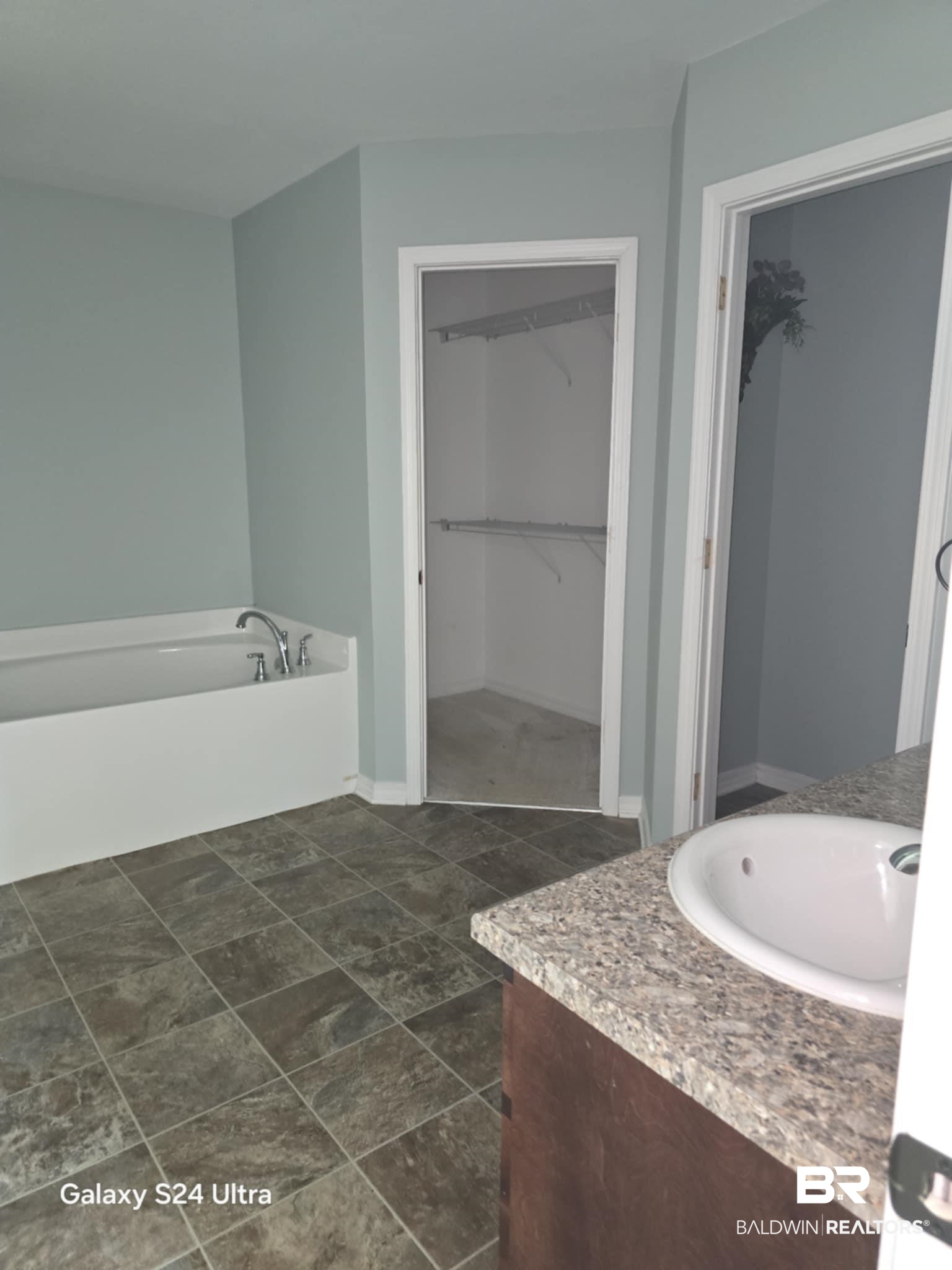 546 Wolf Log Road Flomaton, AL 36441 - Photo 6 of 15 Bathroom featuring vanity, a bath, and tile patterned flooring