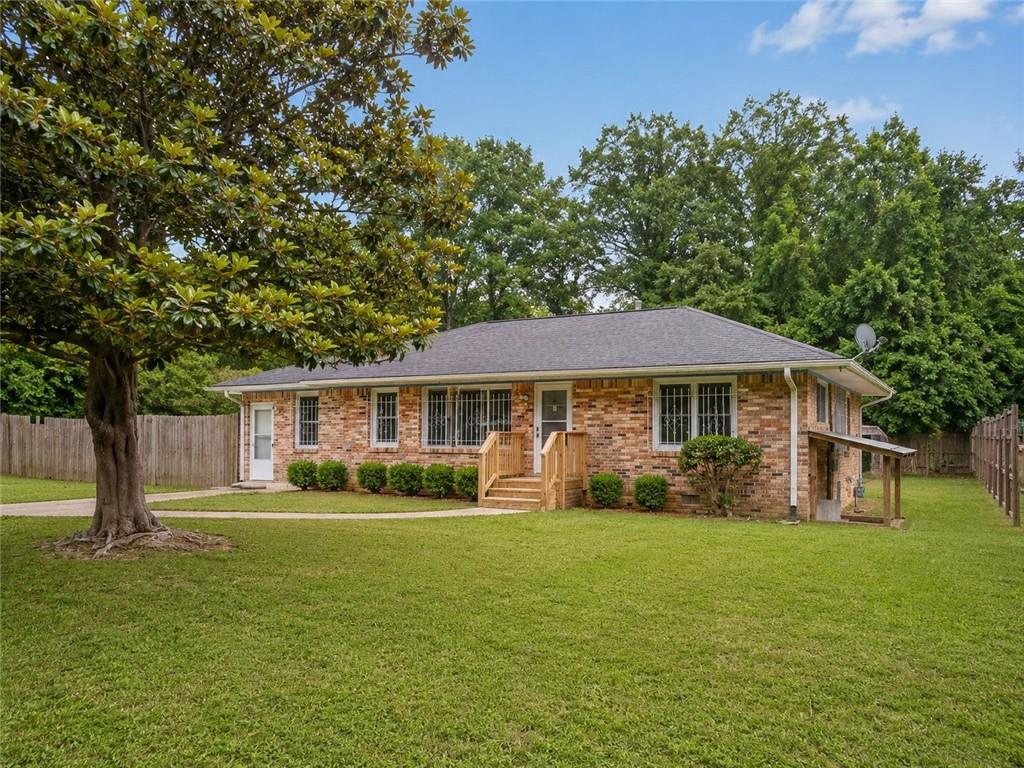 1189 Rock Cut Road Forest Park, GA 30297 - Photo 5 of 23 a front view of a house with garden