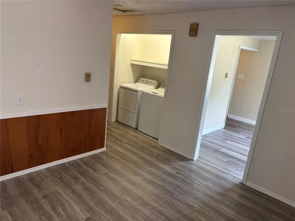 a view of hallway with wooden floor