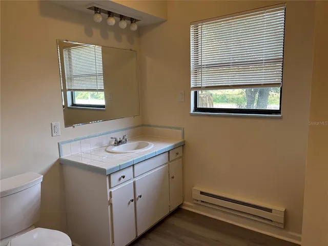 a bathroom with a sink window and mirror
