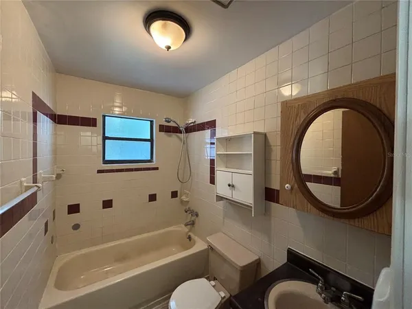 a bathroom with a sink a bathtub and a mirror