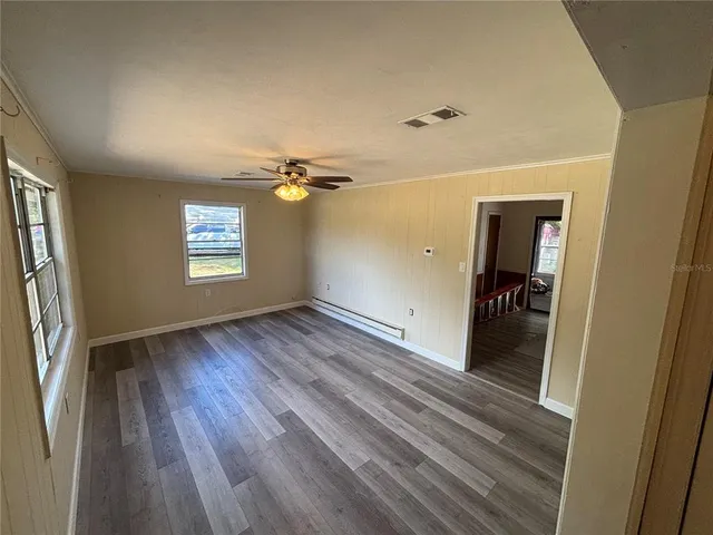 wooden floor in an empty room with a window