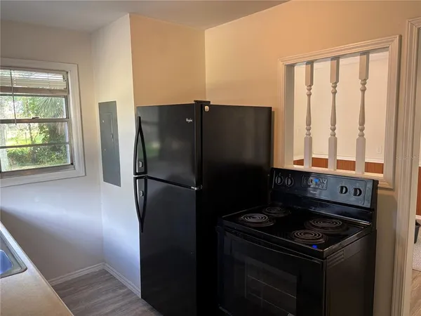 a kitchen with a refrigerator and a window