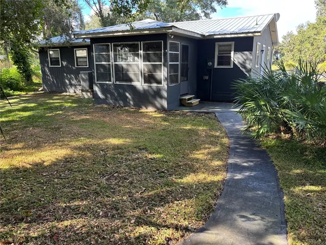 a view of house with yard