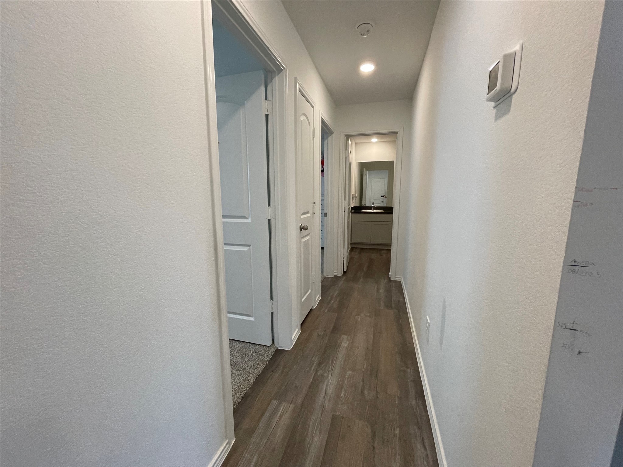 23811 Desert Brush Ct Spring Spring, TX 77373 - Photo 11 of 24 a view of a hallway with wooden floor and a bathroom