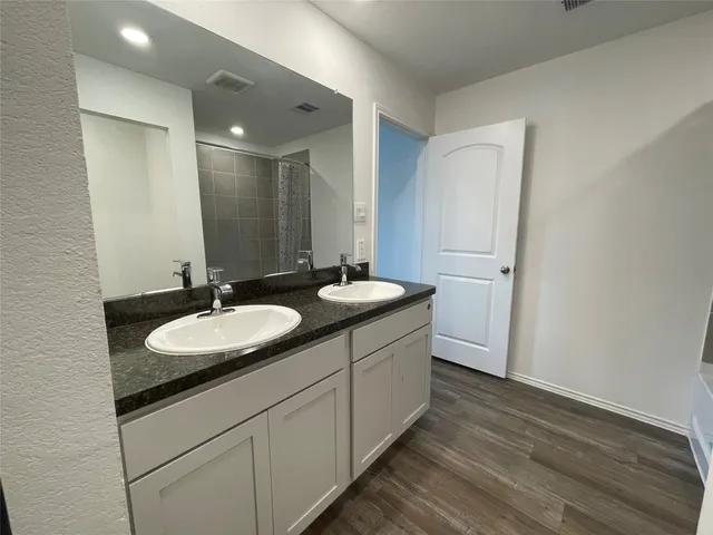 a bathroom with a double vanity sink and mirror