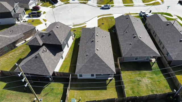 an aerial view of residential houses with outdoor space