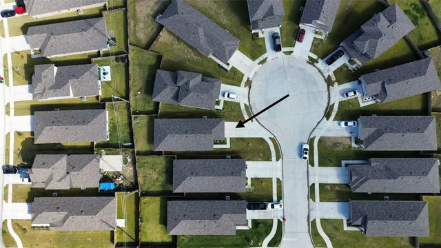 an aerial view of houses with outdoor space