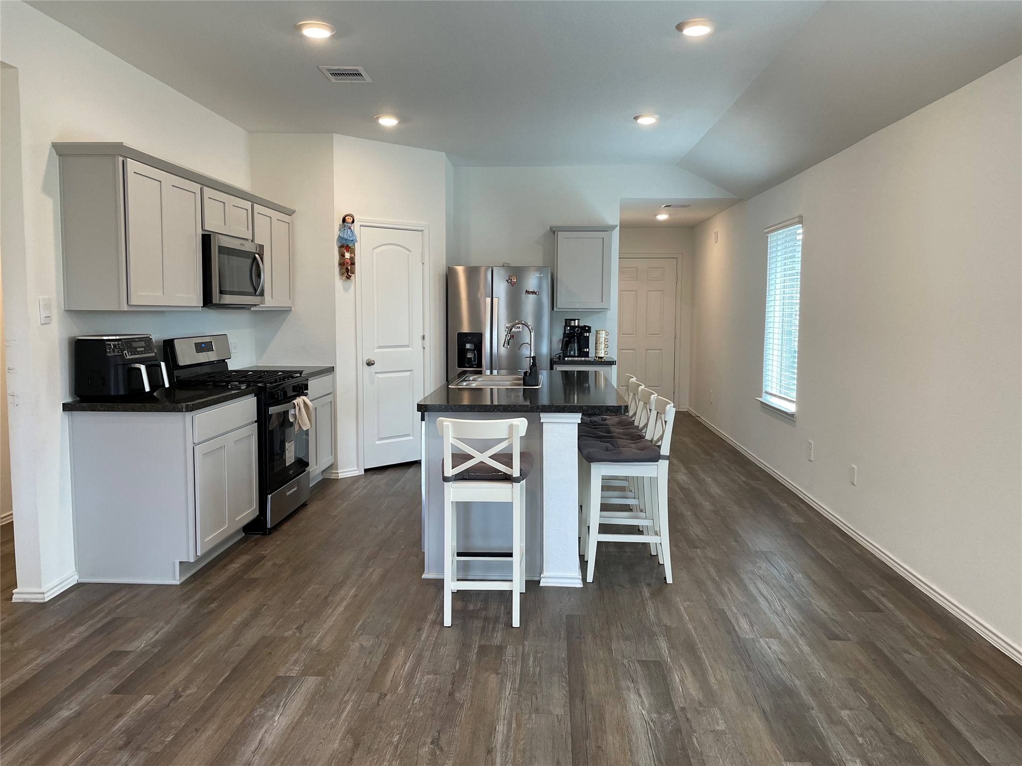 23811 Desert Brush Ct Spring Spring, TX 77373 - Photo 7 of 24 a kitchen with stainless steel appliances a dining table chairs and wooden floor