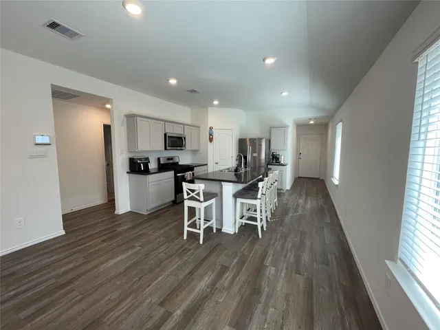a kitchen with a table and chairs in it