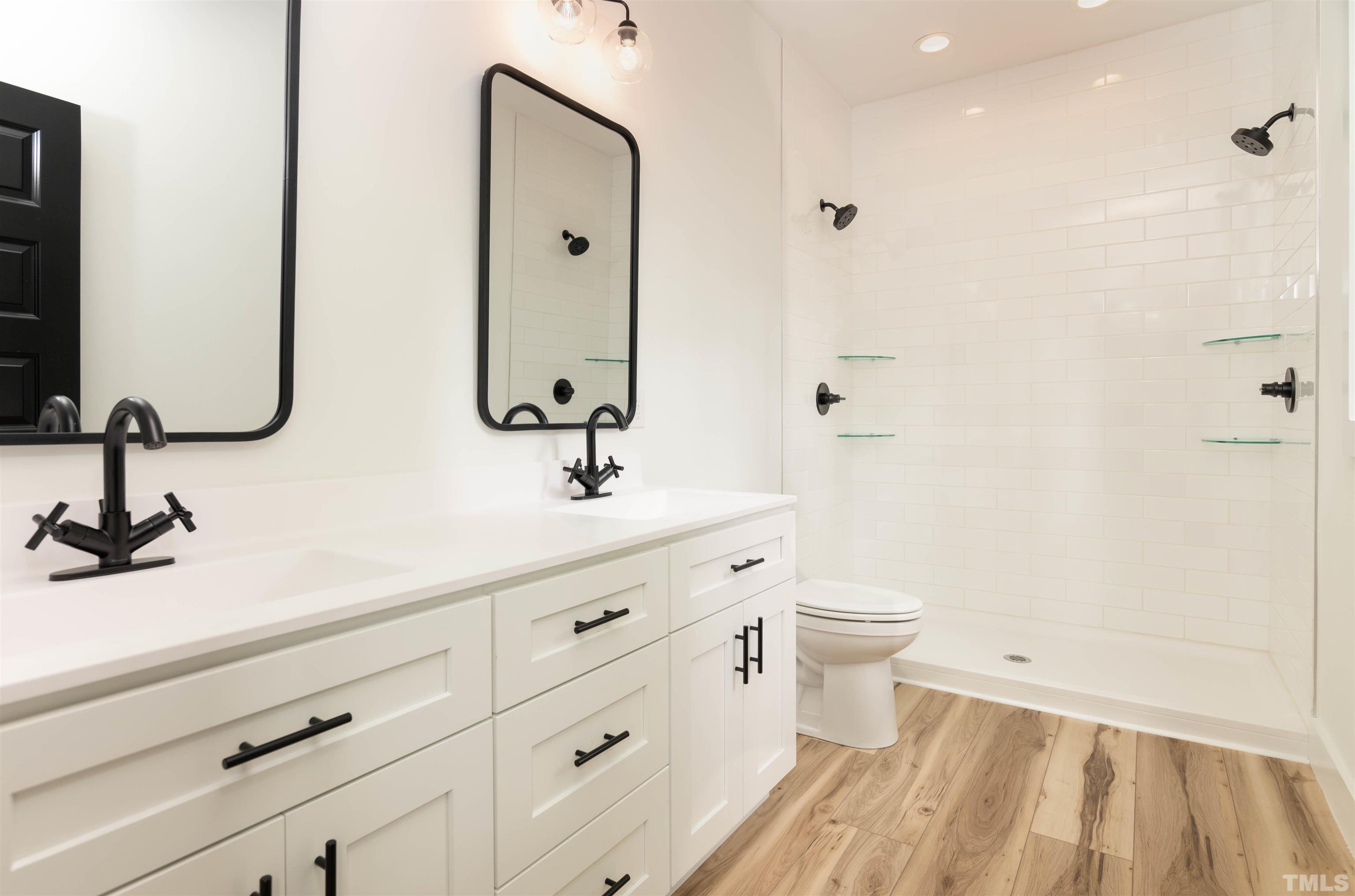 3602 Moriah Road Rougemont, NC 27572 - Photo 8 of 26 a bathroom with a double vanity sink toilet and shower