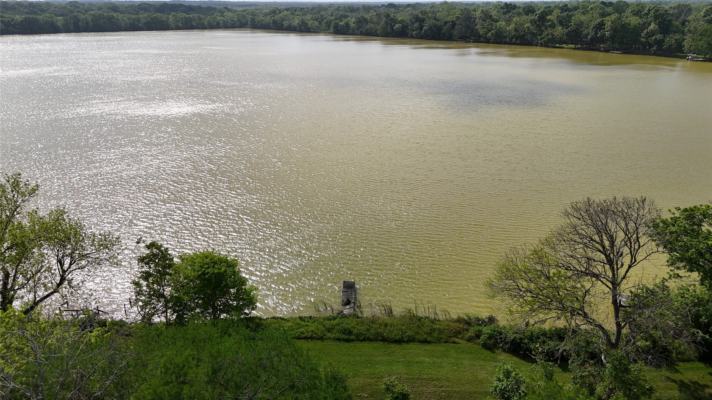 691 County Road 1333 Liberty, TX 77575 - Photo 4 of 24 a view of a lake from a yard