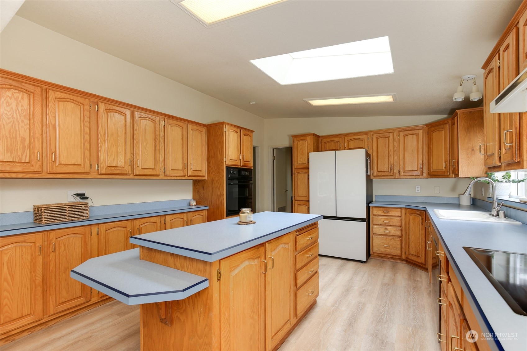 3374 Best Road Oak Harbor, WA 98277 - Photo 13 of 39 a kitchen with stainless steel appliances granite countertop a sink dishwasher stove refrigerator and cabinets with wooden floor
