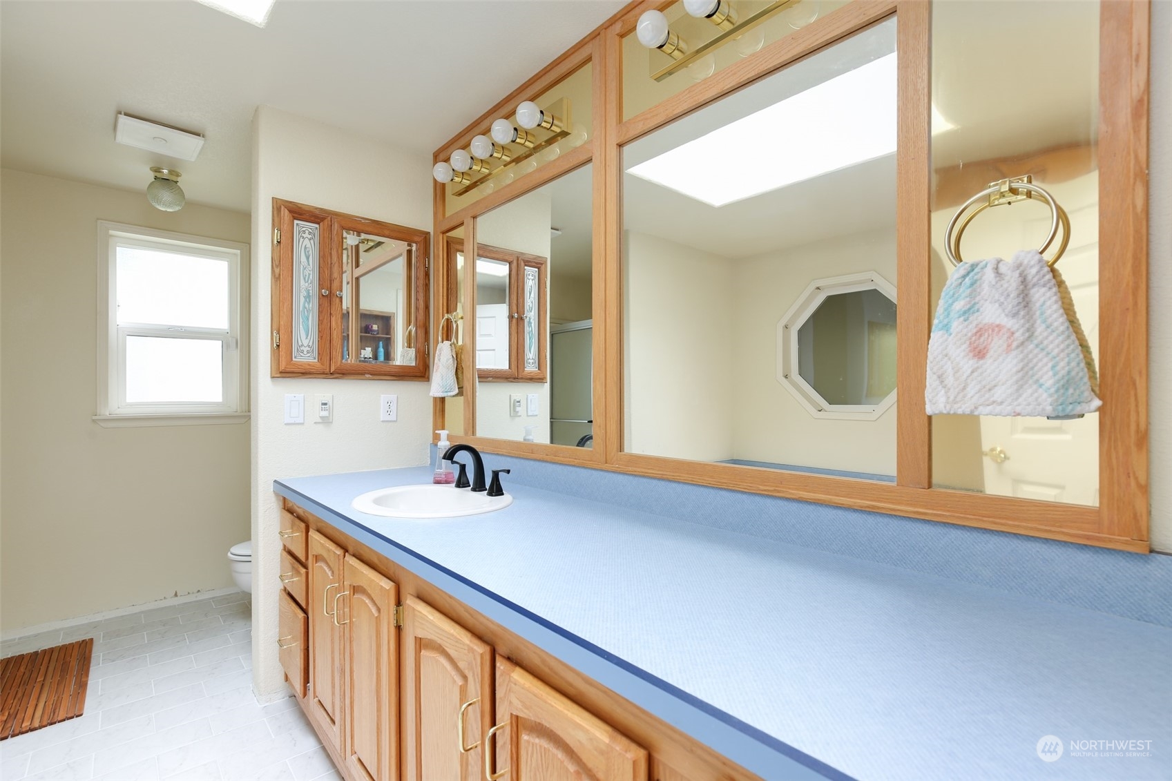 3374 Best Road Oak Harbor, WA 98277 - Photo 22 of 39 a bathroom with a sink a mirror and a window