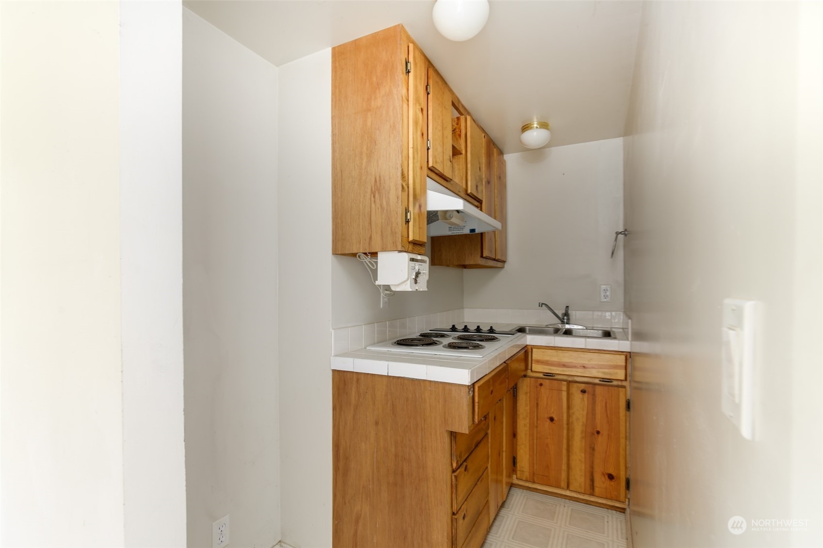 3374 Best Road Oak Harbor, WA 98277 - Photo 31 of 39 a utility room with a sink a mirror and cabinets