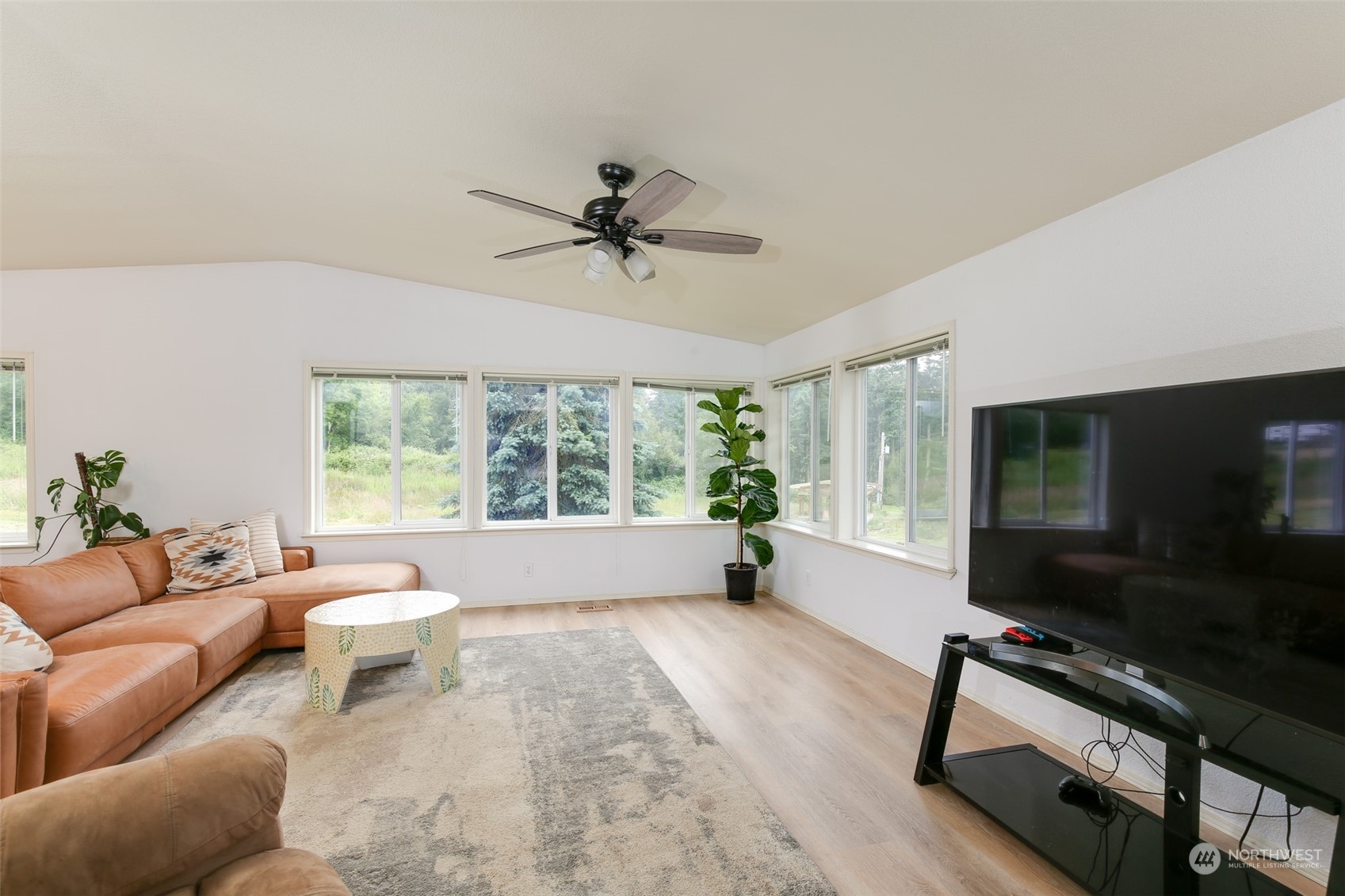 3374 Best Road Oak Harbor, WA 98277 - Photo 9 of 39 a living room with furniture a flat screen tv and a window