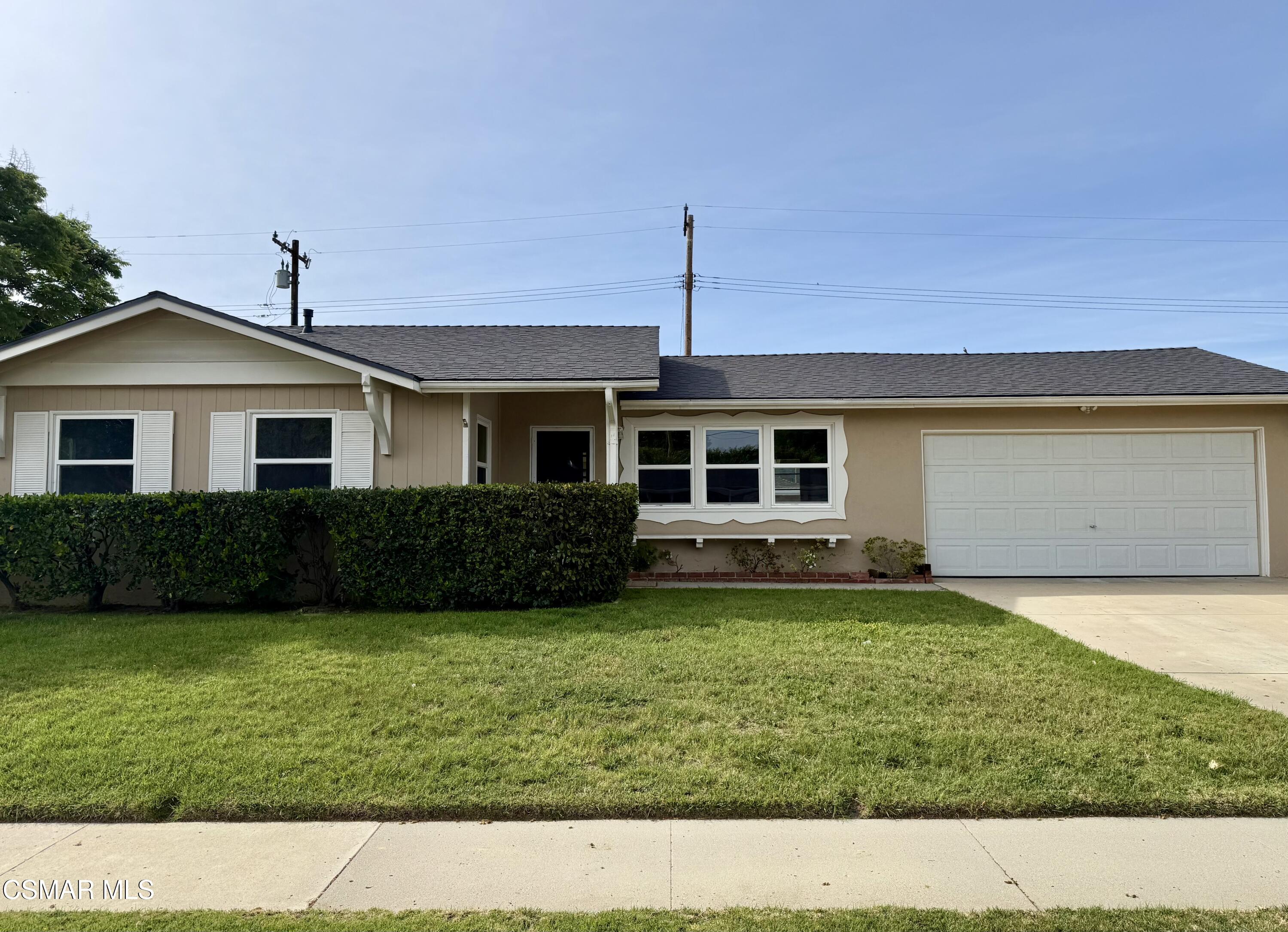 4090 Florence Street Simi Valley, CA 93063 - Photo 2 of 16 a front view of a house with a garden