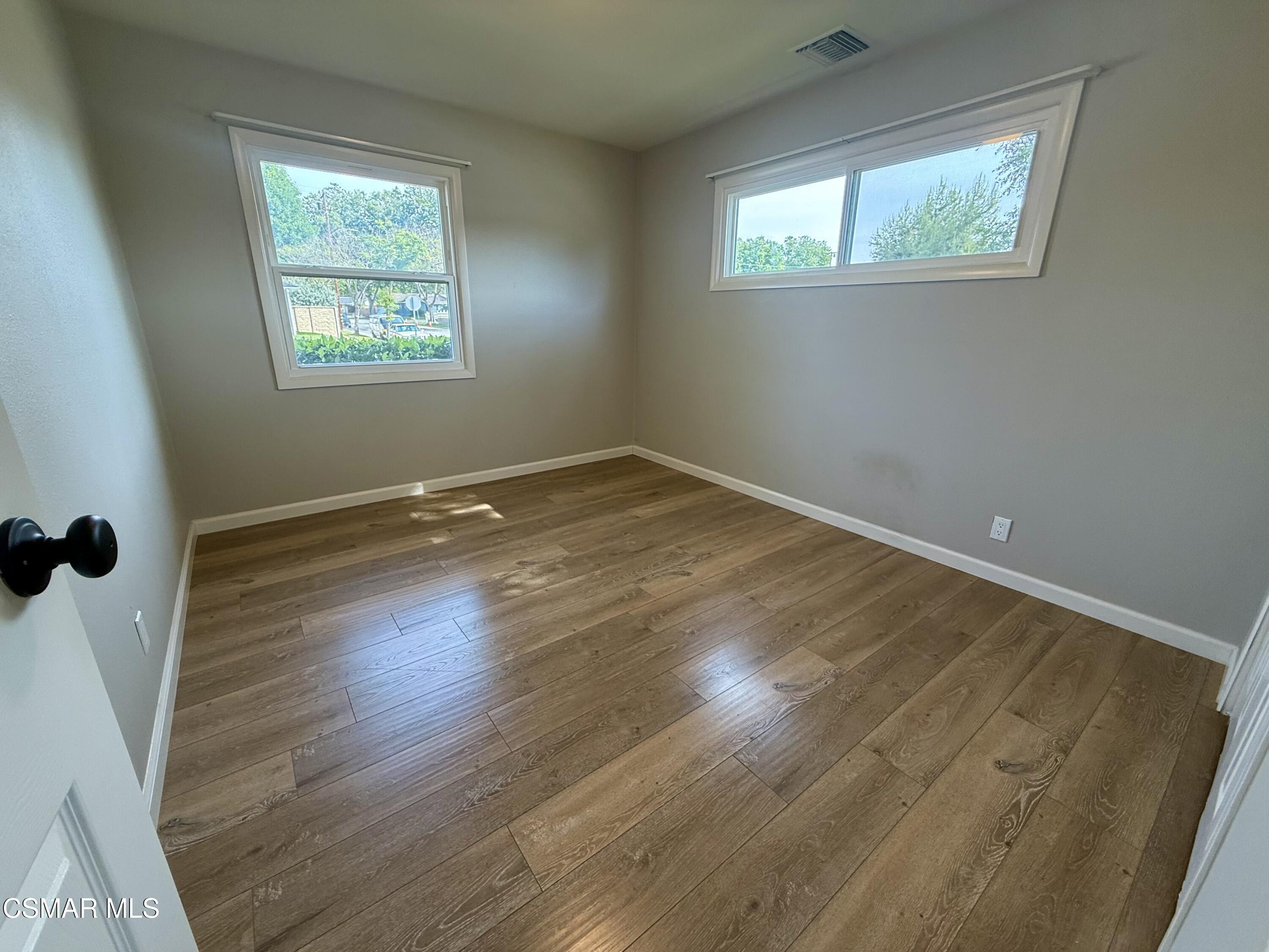 4090 Florence Street Simi Valley, CA 93063 - Photo 9 of 16 a view of an empty room with wooden floor and a window