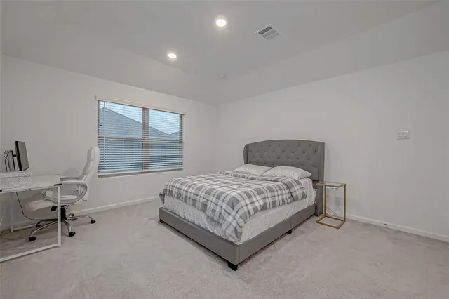 a bedroom with a bed chair and a window