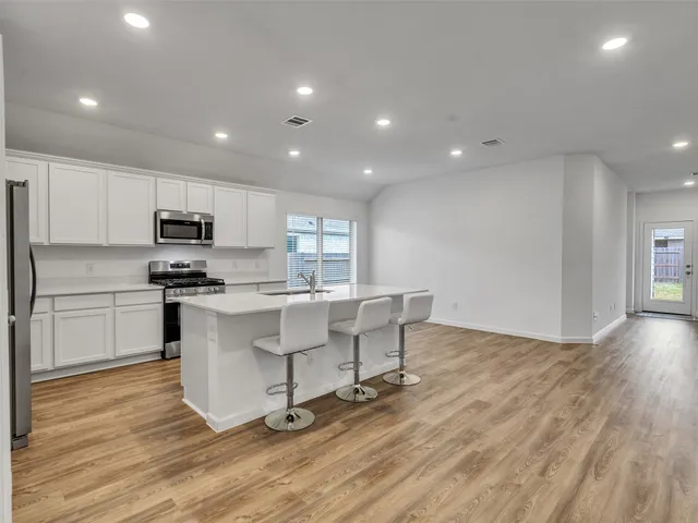 a kitchen with a sink stainless steel appliances and cabinets