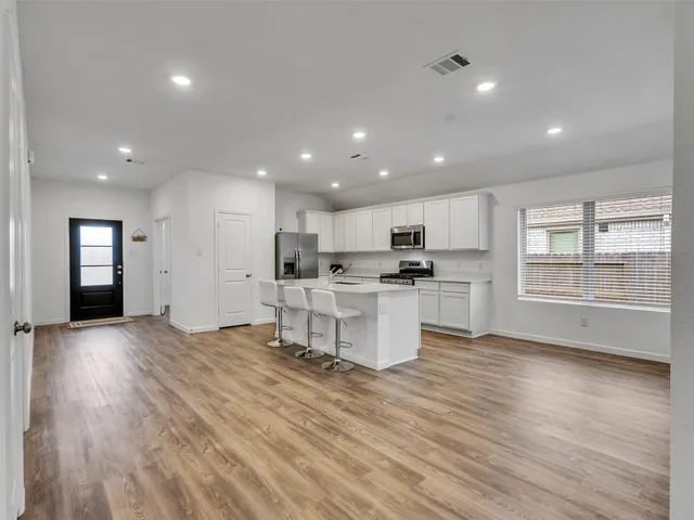 a view of kitchen with cabinets and wooden floor