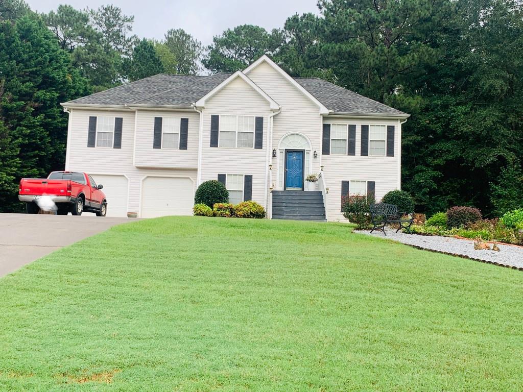 120 Falls Crossing Covington, GA 30016 - Photo 1 of 1 a front view of a house with a garden