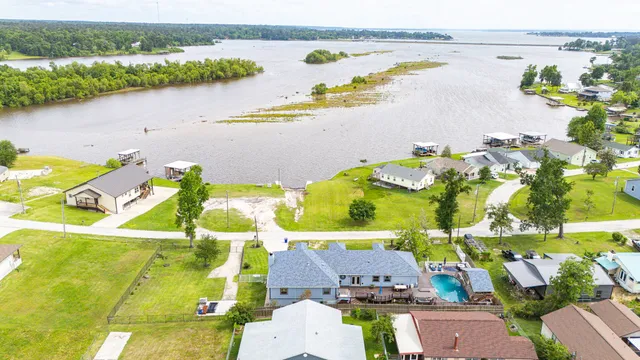 an aerial view of a house with a lake view