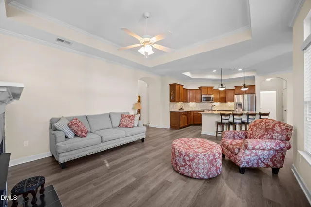 a living room with furniture and wooden floor