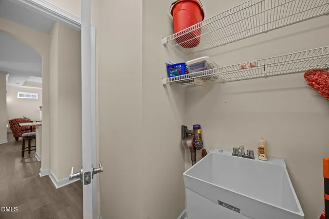 a room with a wooden floor and sink