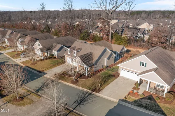 an aerial view of a house with large trees