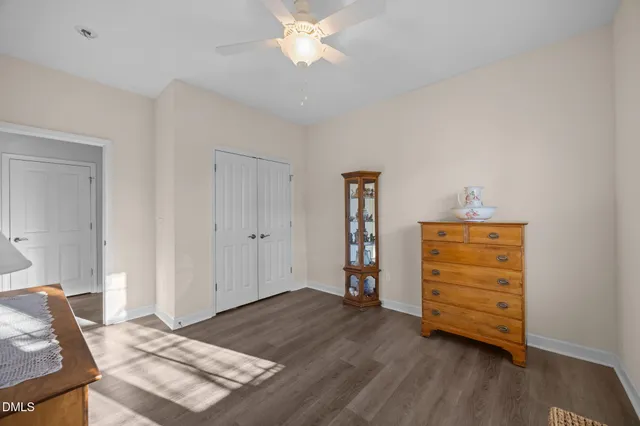 a view of a bedroom with furniture and wooden floor