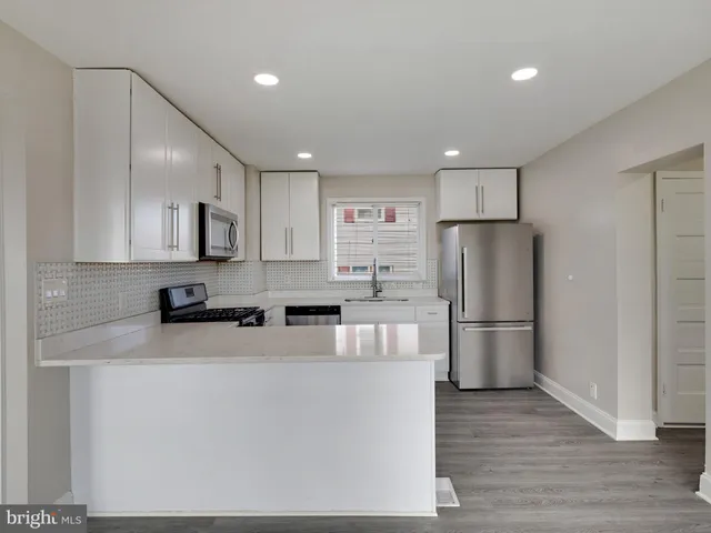 a kitchen with stainless steel appliances a refrigerator sink and cabinets