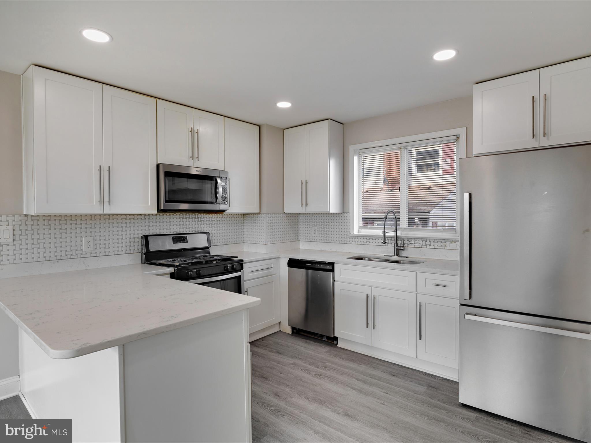 4129 5th Street Baltimore, MD 21225 - Photo 15 of 52 a kitchen with a refrigerator stove and microwave