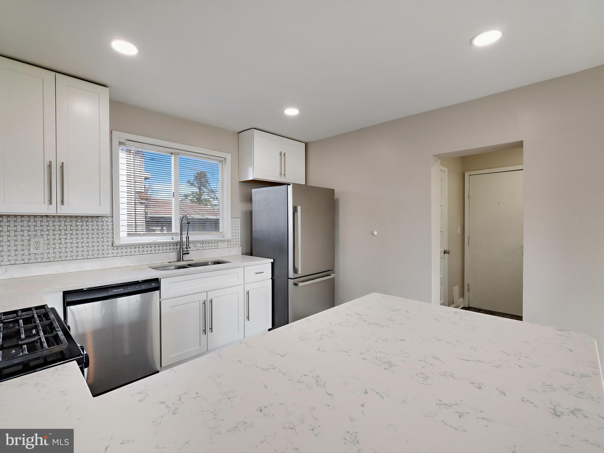 4129 5th Street Baltimore, MD 21225 - Photo 16 of 52 a kitchen with stainless steel appliances granite countertop a refrigerator sink and stove