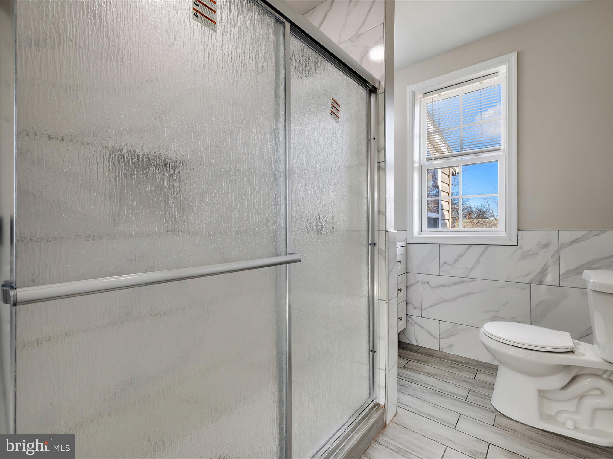4129 5th Street Baltimore, MD 21225 - Photo 22 of 52 a bathroom with a toilet and a shower