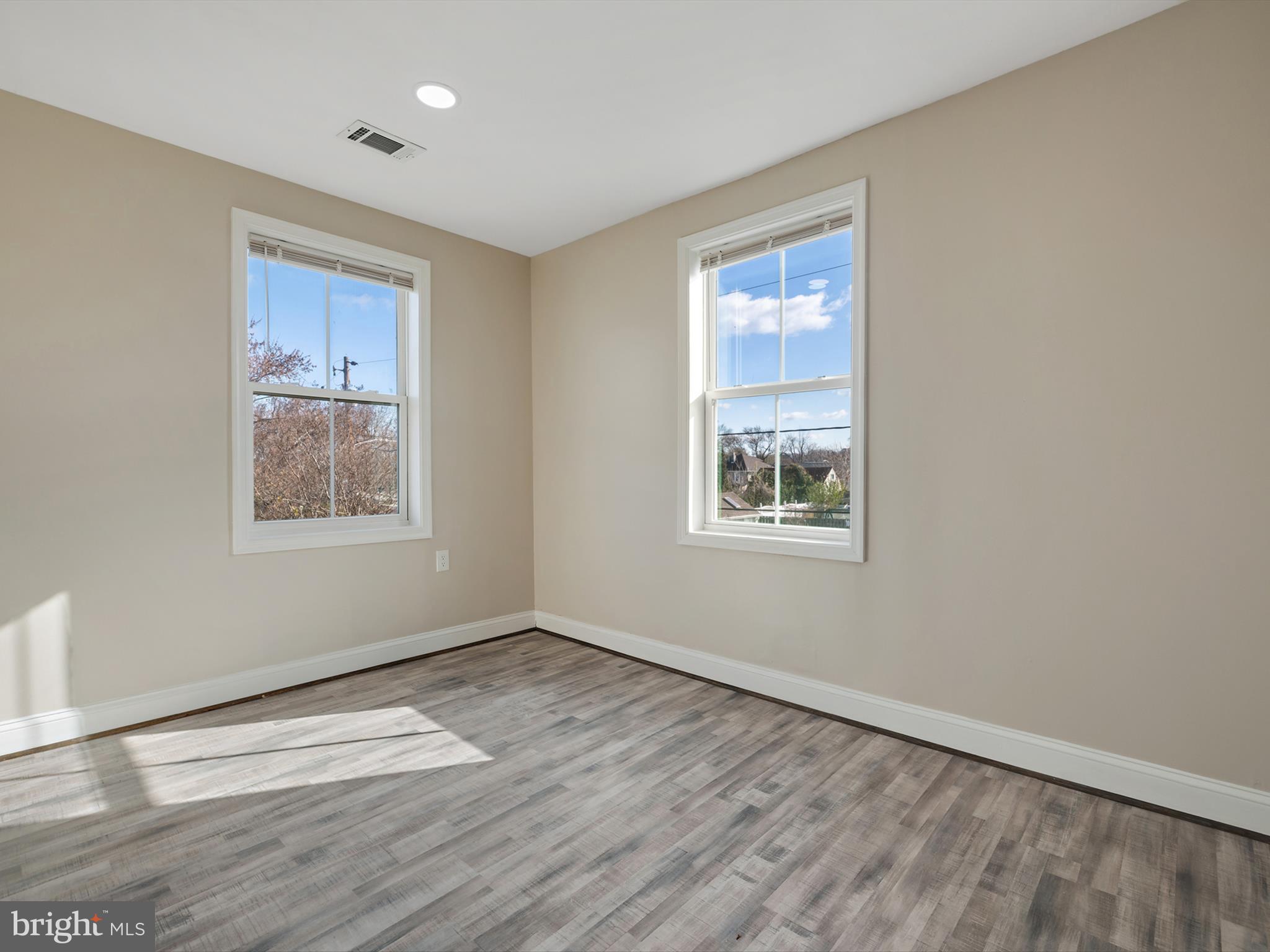 4129 5th Street Baltimore, MD 21225 - Photo 24 of 52 a view of an empty room with wooden floor and a window