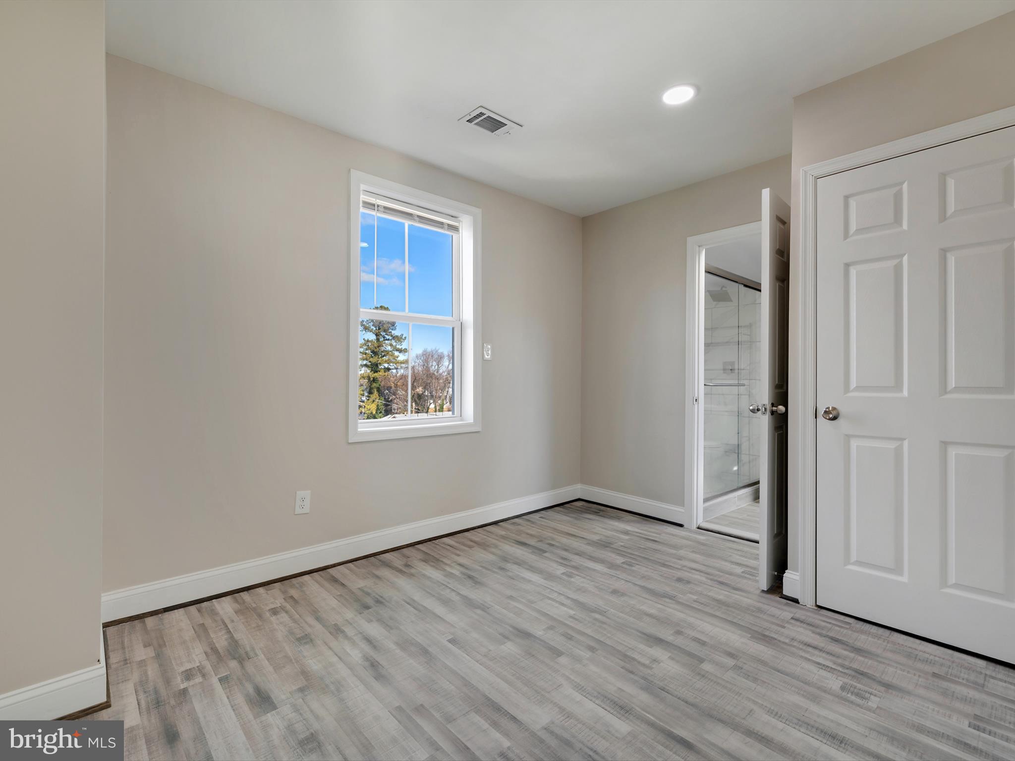4129 5th Street Baltimore, MD 21225 - Photo 26 of 52 an empty room with wooden floor and windows