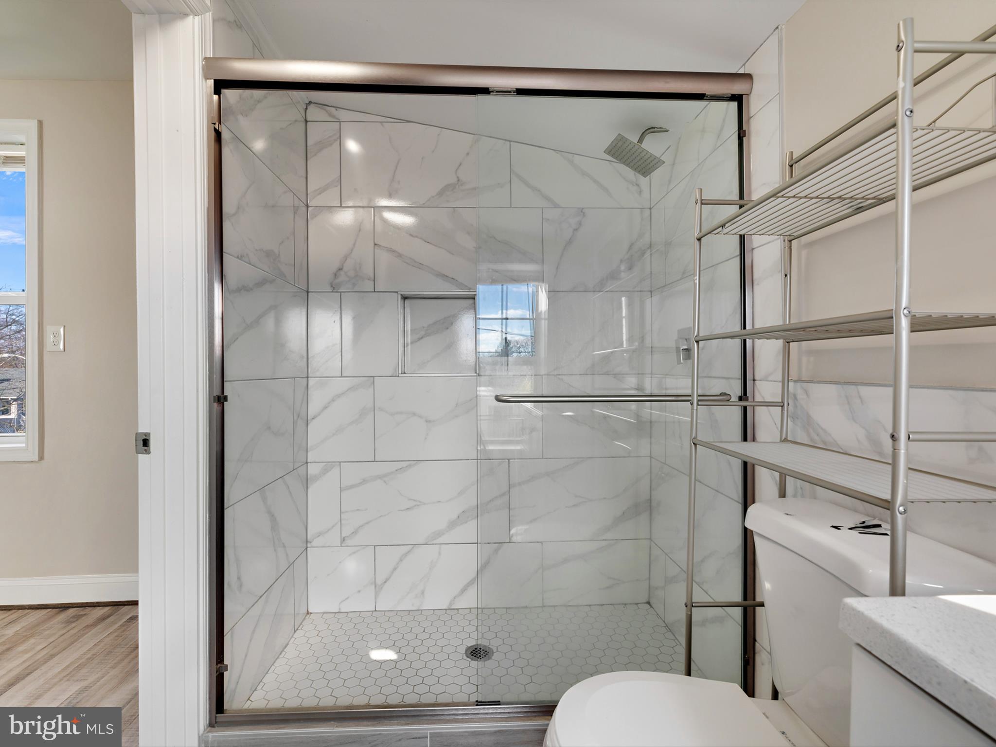 4129 5th Street Baltimore, MD 21225 - Photo 29 of 52 a bathroom with a shower and toilet