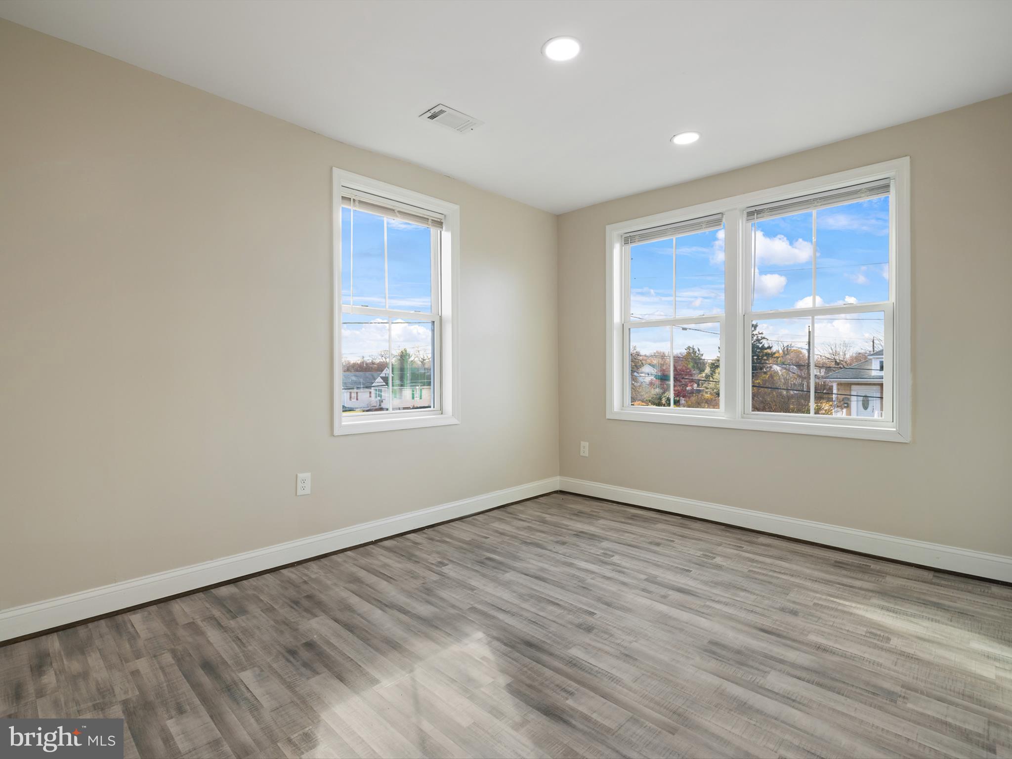 4129 5th Street Baltimore, MD 21225 - Photo 30 of 52 a view of an empty room with wooden floor and a window