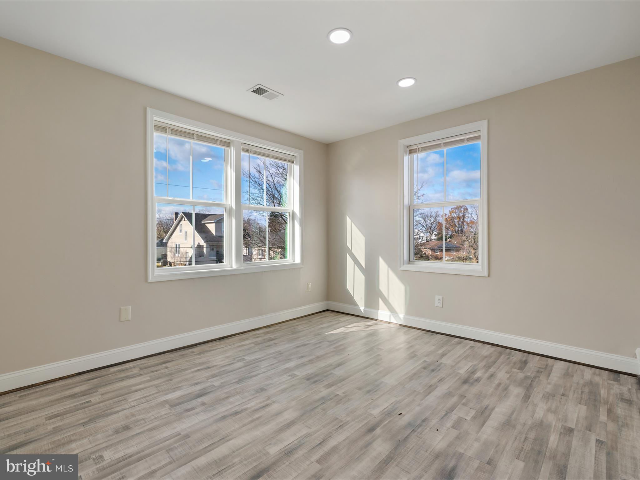 4129 5th Street Baltimore, MD 21225 - Photo 32 of 52 a view of an empty room with window and wooden floor