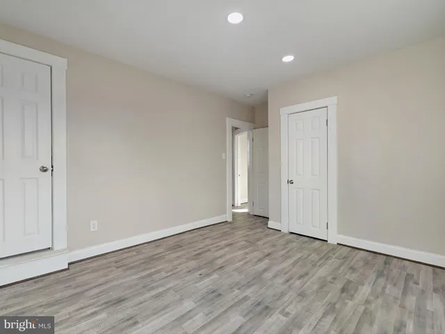 an empty room with windows and closet