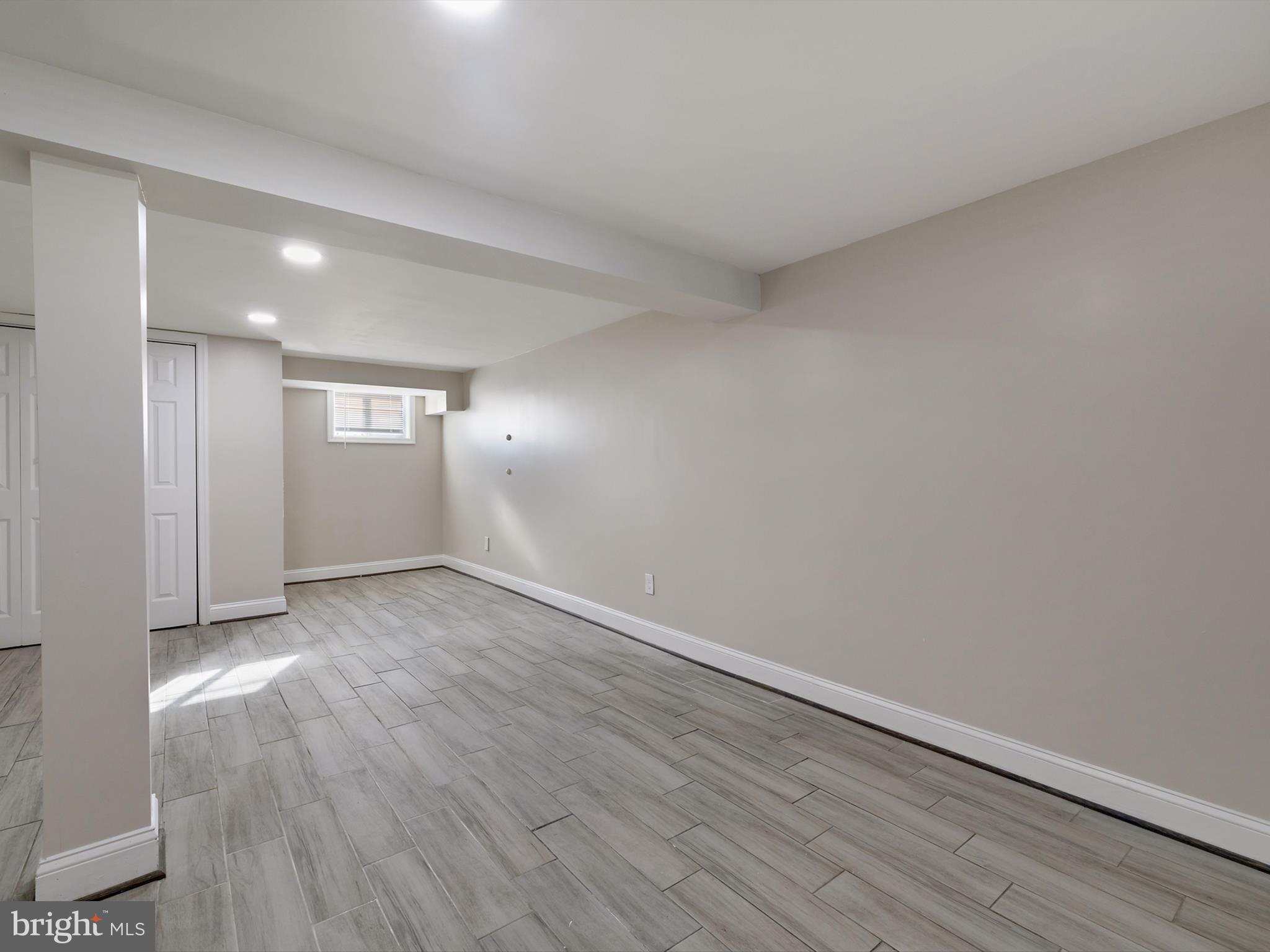 4129 5th Street Baltimore, MD 21225 - Photo 37 of 52 an empty room with wooden floor and windows
