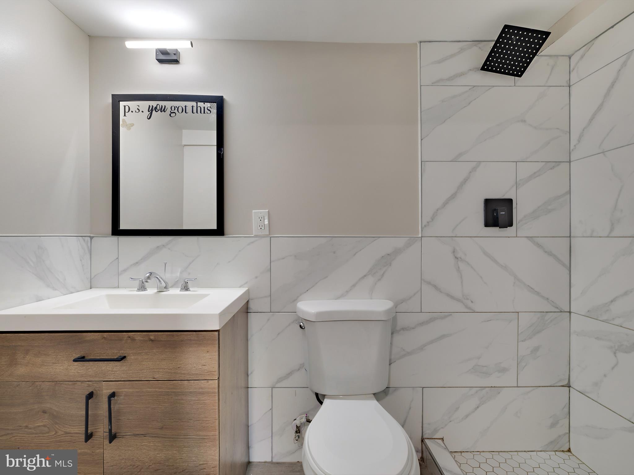 4129 5th Street Baltimore, MD 21225 - Photo 41 of 52 a bathroom with a toilet sink and mirror