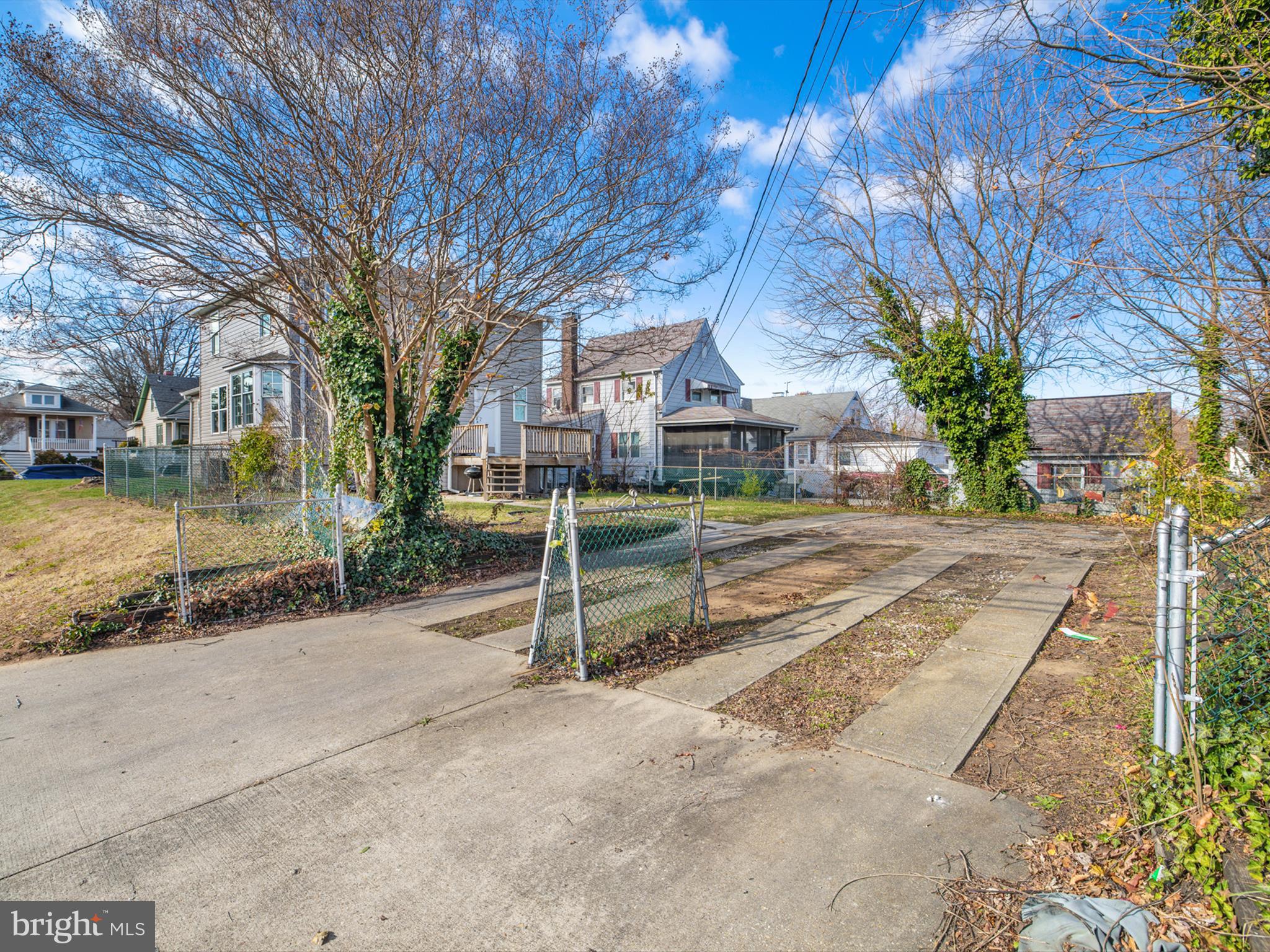 4129 5th Street Baltimore, MD 21225 - Photo 45 of 52 a view of a house with a yard and large tree