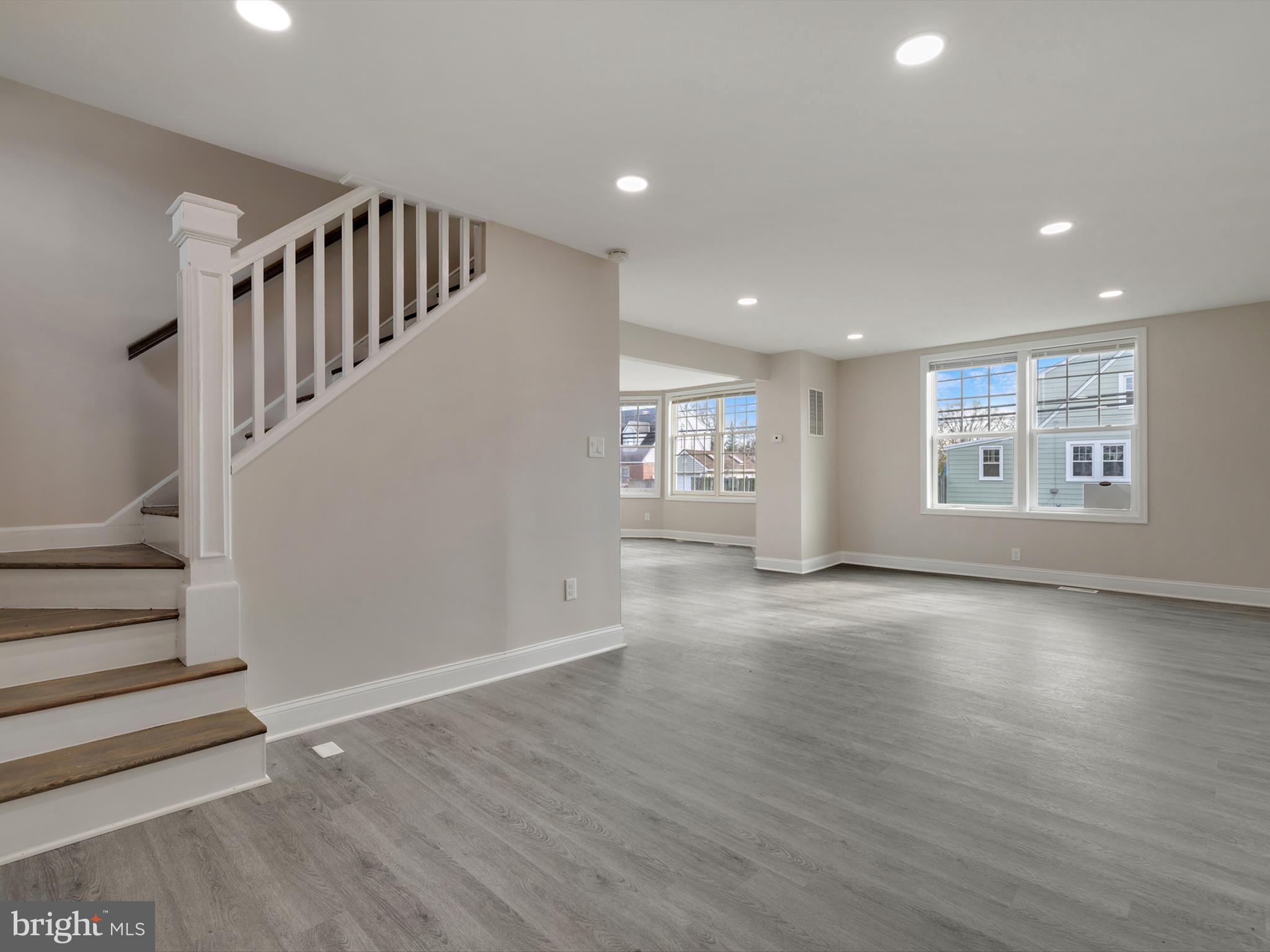 4129 5th Street Baltimore, MD 21225 - Photo 5 of 52 a view of an empty room with a window and wooden floor