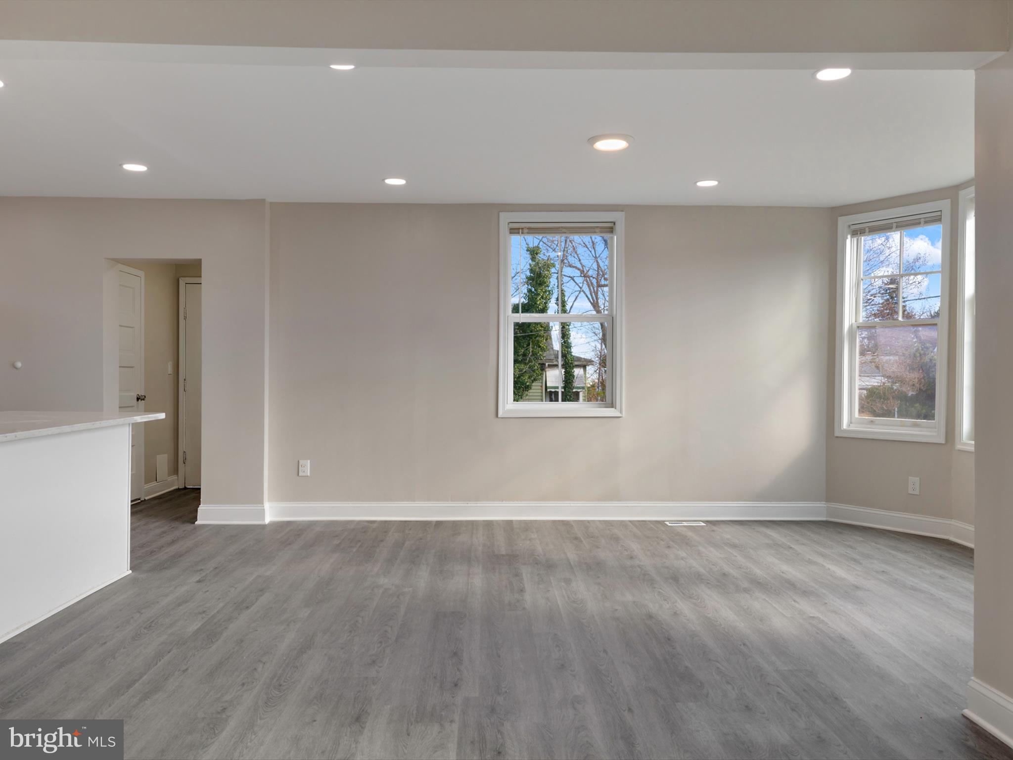 4129 5th Street Baltimore, MD 21225 - Photo 10 of 52 an empty room with wooden floor and windows
