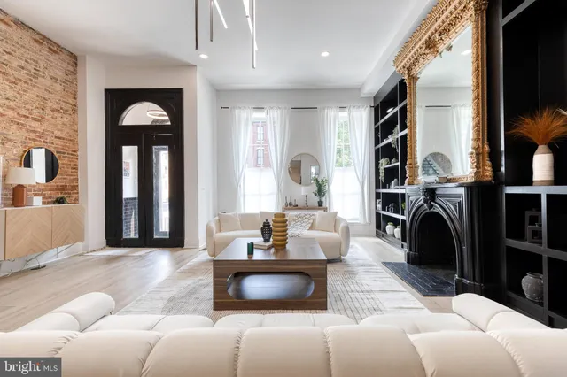 a kitchen with stainless steel appliances granite countertop a refrigerator a sink dishwasher a stove and a dining table with wooden floor