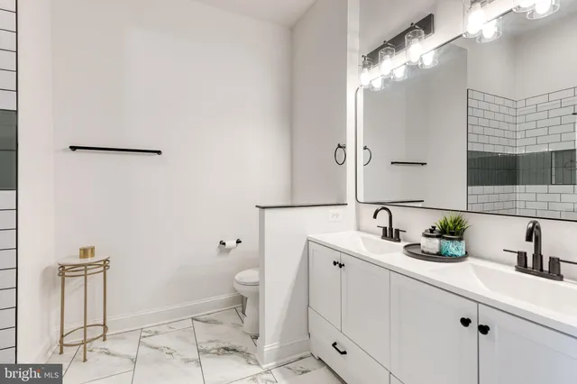 a view of staircase with wooden floor and white walls