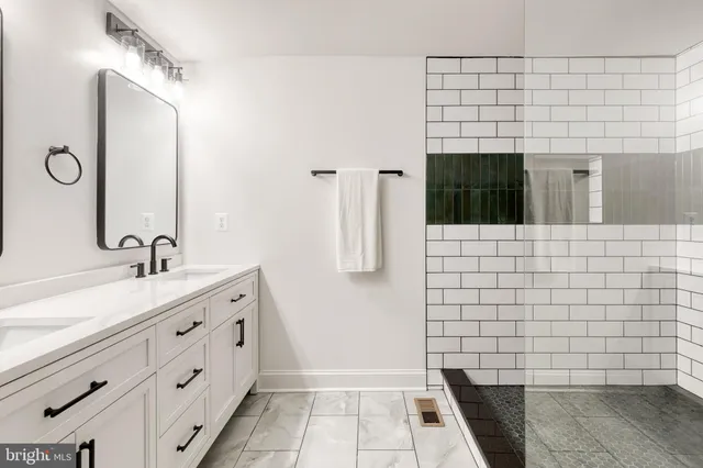 a bathroom with a sink a granite and mirror