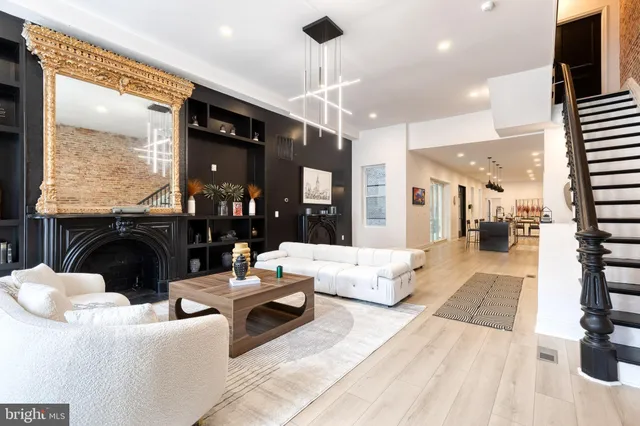 a living room with furniture a large window and a fireplace